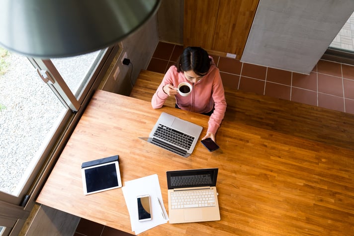 Top view of woman drinking of coffee with checking the message on cellphone